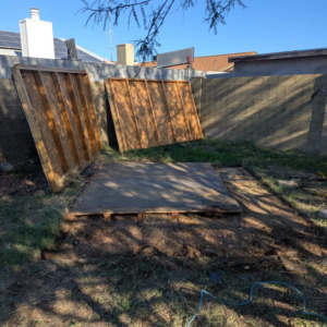 Disassembled shed walls and base in a backyard, ready for junk removal by J & R Junk Removal in Phoenix, AZ.