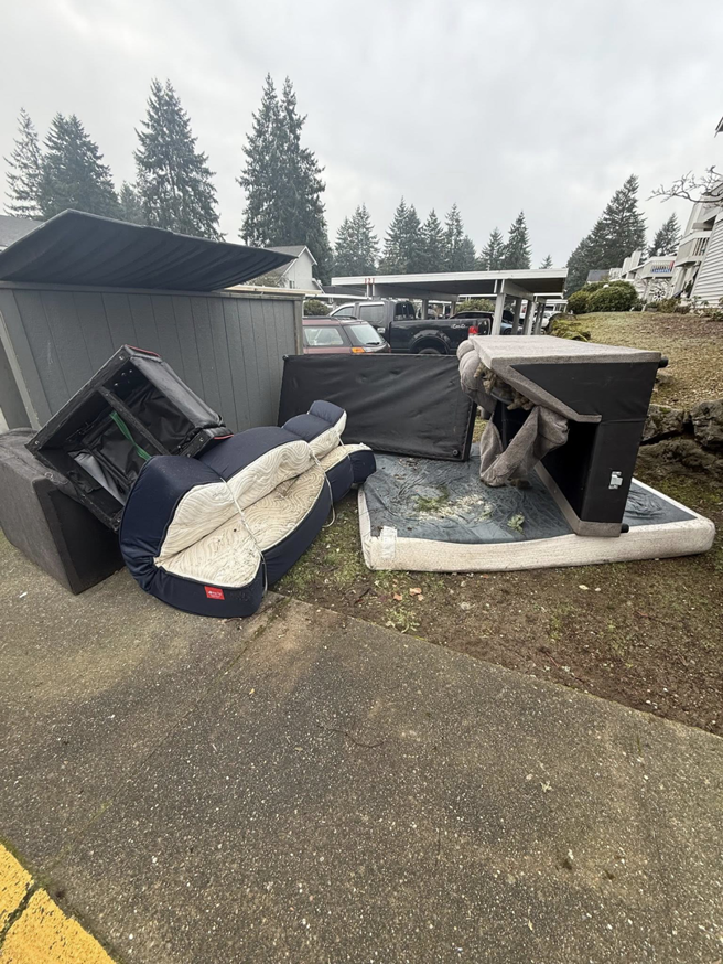Piles of discarded furniture and a mattress waiting for pickup by All City Junk Removal in Kent, WA.