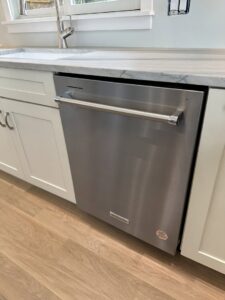 A new stainless steel dishwasher installed under a kitchen countertop by R&J Handyman Services LLC in Warwick, RI.