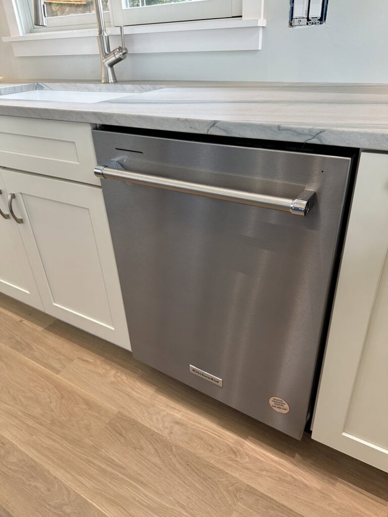 A stainless steel dishwasher newly installed under a kitchen countertop by R&J Handyman Services LLC in Warwick, RI.