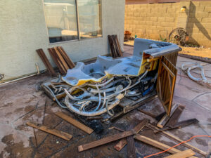 Debris from a dismantled hot tub scattered on a patio, ready for removal by Junk Junkees in Peoria, AZ.