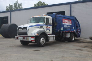 A blue and white Disposall garbage truck ready for general junk removal service in Orlando, FL.
