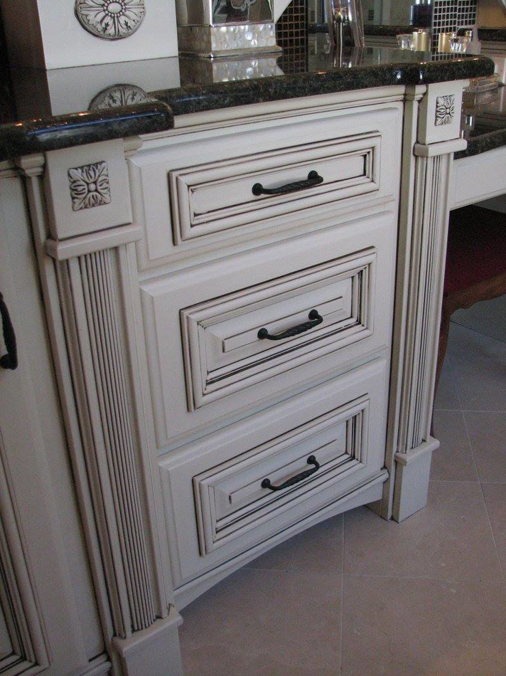 Close-up of distressed white cabinet drawers with black handles, installed by Metro Contractors & Supply, Inc. in Norman, OK