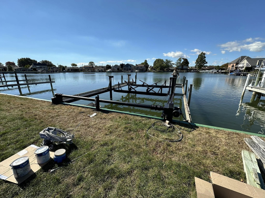 An overview of a dock and boat lift construction site with tools by TopNotch Remodeling & Restoration Service LLC in Warren, MI