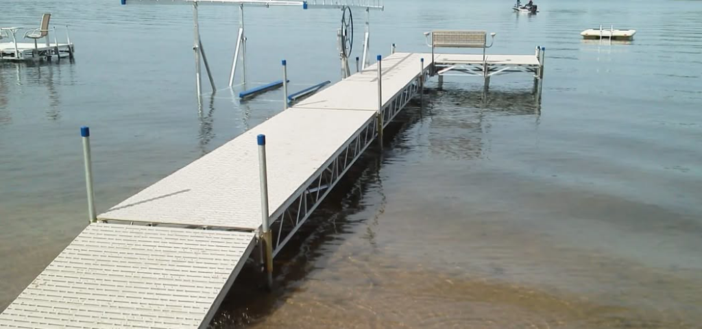 An extensive dock system with a boat lift, expertly installed by Walks On Water, Inc in Clear Lake, MN