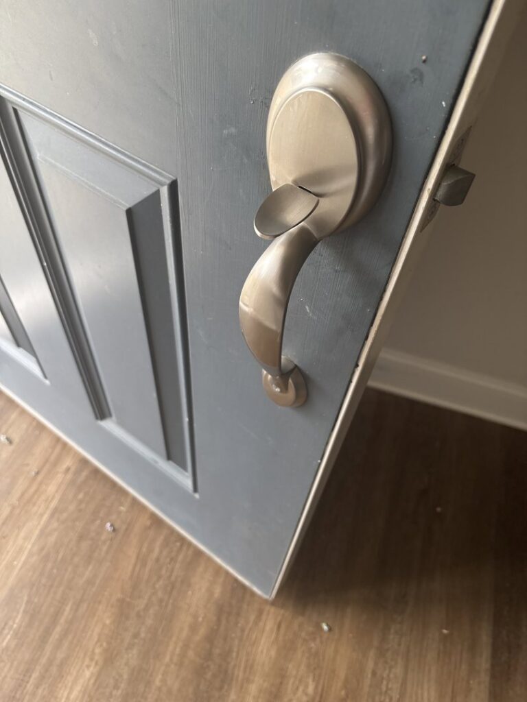 A close-up of a newly installed door handle and lockset, a handyman service by Lula - Reinventing Property Maintenance in Overland Park, KS.