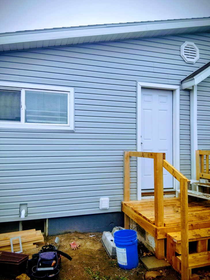 New door installation, deck framing, and siding work by Investment Handyman Services in Pocatello, ID