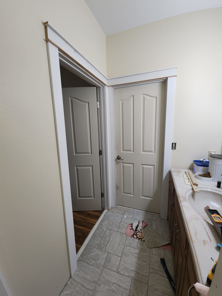 New door trim being installed in a bathroom by Sir Fix-A-Lot Handyman Services, LLC in Palmer, AK.