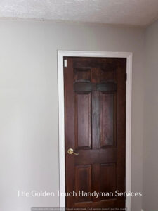 A newly painted door and trim, showcasing painting services by The Golden Touch handyman services in Huntington, WV.