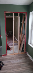A doorway being framed during an interior renovation project, with drywall sheets ready by NewEra Construction & Solutions in Lexington, KY