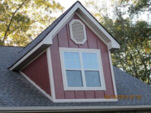 A dormer with new siding and window on a roof, showcasing work by JON Construction, Inc. in Allentown, PA.