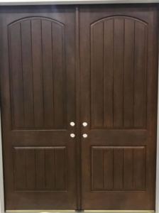 Newly installed double dark wood entry doors with arched tops by The Window & Door Gallery in Elizabethtown, KY.