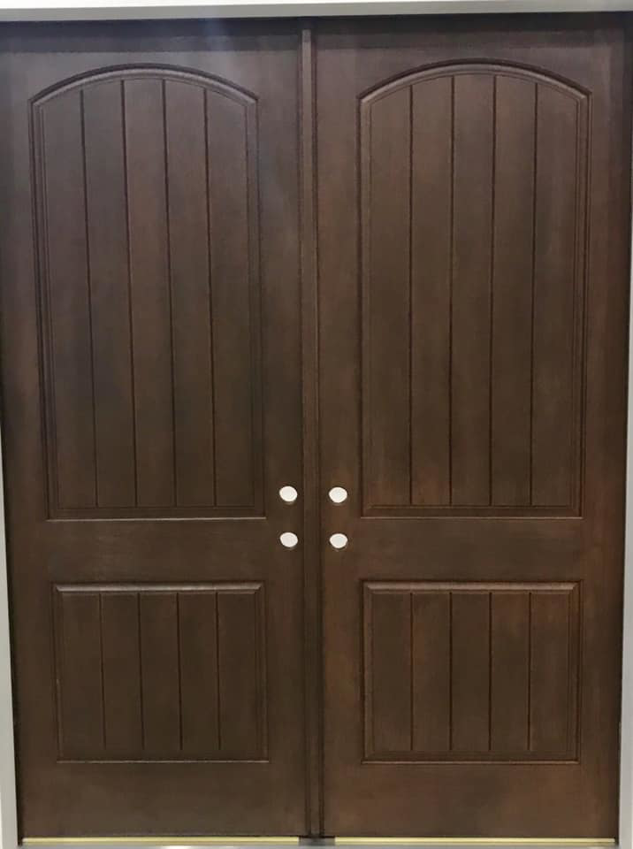 Newly installed double dark wood entry doors with arched tops by The Window & Door Gallery in Elizabethtown, KY.