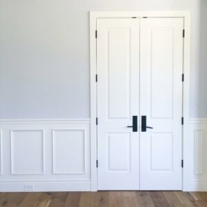 Double interior door installation with wainscoting and trim by Mountain Door and Trim in Phoenix, AZ.
