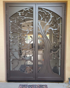 Double security screen door with a decorative tree design installed by Steel Creations & Fabrication, INC in Glendale, AZ