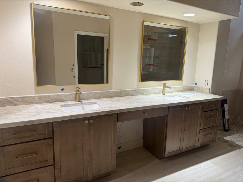 A newly installed double vanity bathroom with modern mirrors and cabinetry by Integrity Contracting in Cleveland, OH
