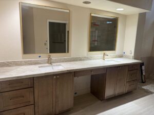 A newly installed double vanity bathroom with modern mirrors and cabinetry by Integrity Contracting in Cleveland, OH