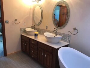 A bathroom remodel featuring a double vanity and freestanding tub by Indy Renovation in Indianapolis, IN.