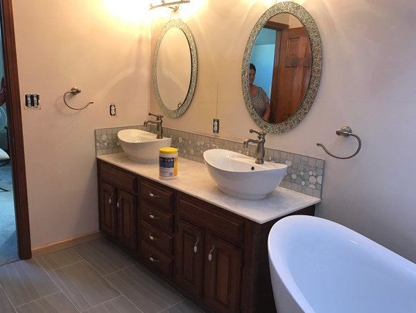 A bathroom remodel featuring a double vanity and freestanding tub by Indy Renovation in Indianapolis, IN.