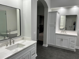 Completed bathroom remodel showcasing double vanities and modern mirrors by Master Building & Remodeling, Inc. in Concord, NC