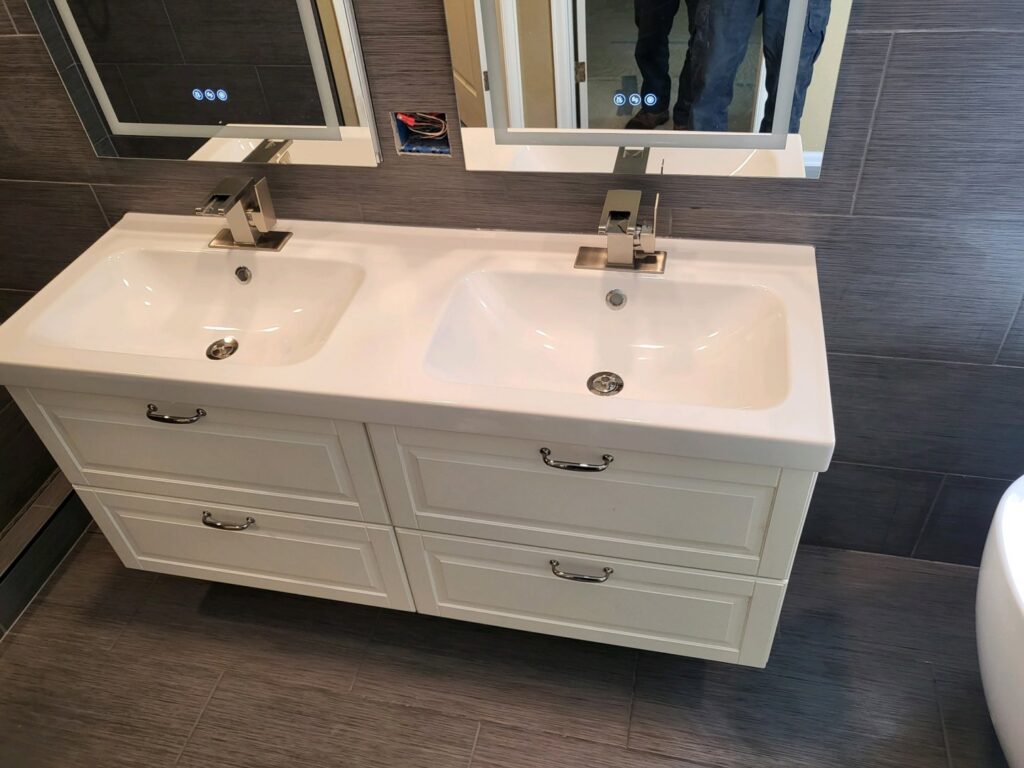 A newly installed double vanity with two sinks and modern faucets, completed by Mr. Affordable LLC in Denver, CO.