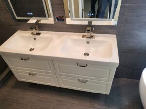 A newly installed double vanity with two sinks and modern faucets, completed by Mr. Affordable LLC in Denver, CO.