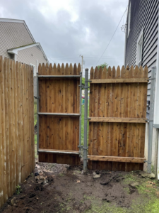 Installation of a double wooden fence gate by Digby Handyman Services LLC in Cranston, RI.