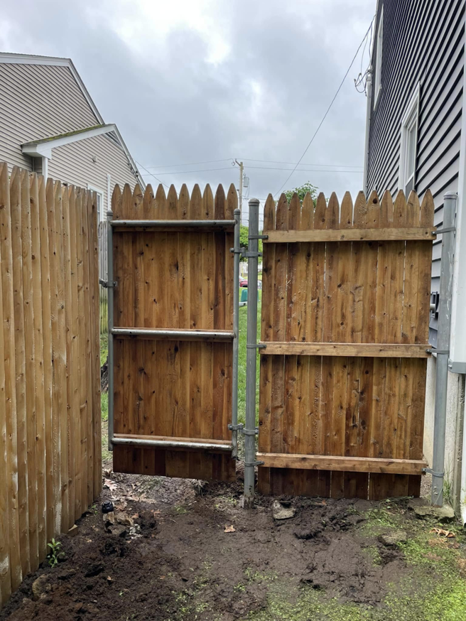 Installation of a double wooden fence gate by Digby Handyman Services LLC in Cranston, RI.