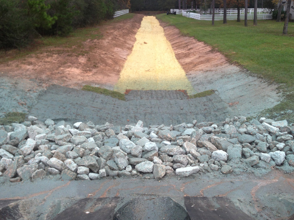 Completed drainage ditch with erosion control and culvert by Daniel Dean Land Clearing & Dirt Work in Houston, TX.