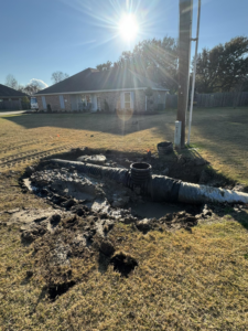 Drainage pipe installation in a trench for a residential property by Rolloff Rentals / Rolloff Services in Port Angeles, WA.