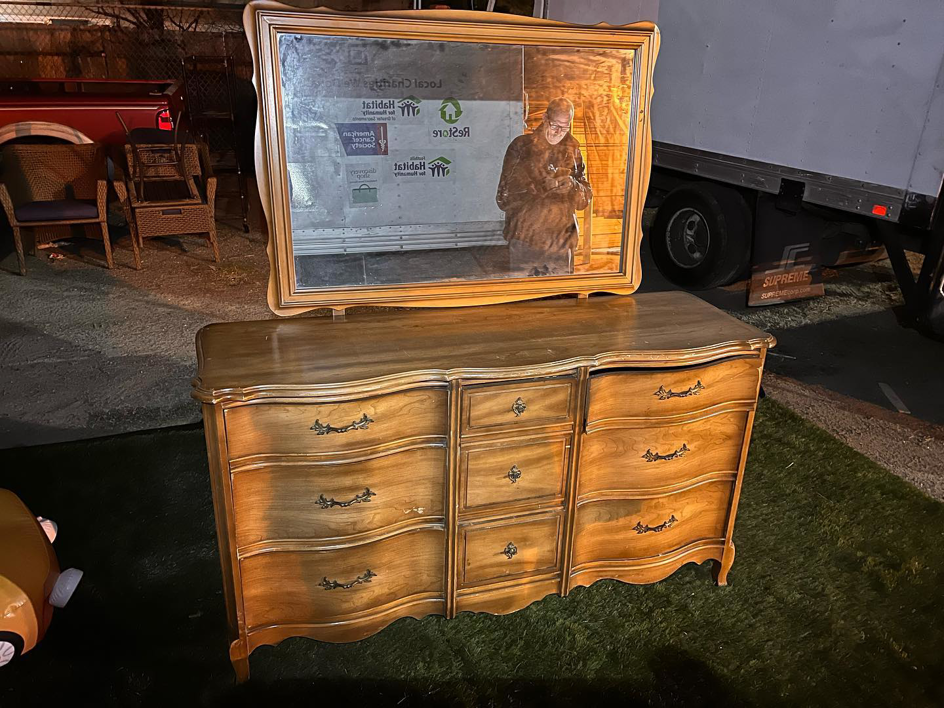A wooden dresser with a mirror placed outdoors, ready for general junk removal by Junk2Dump in Sacramento, CA.