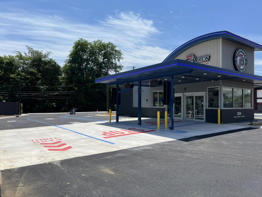Red STOP and white pass-thru markings for a drive-thru lane by Marine One Striping in Clarksville, TN.