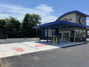 Red STOP and white pass-thru markings for a drive-thru lane by Marine One Striping in Clarksville, TN.