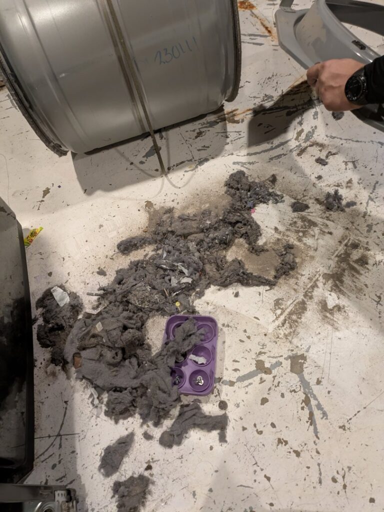 A large pile of lint and debris on the floor from a dryer cleaning service by Appliance Handyman of Twin Falls, ID