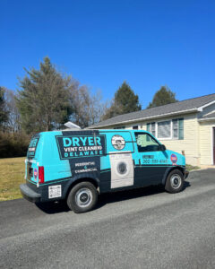 The Dryer Vent Cleaning of Delaware service van parked in front of a residential home in Wilmington, DE, ready for a job.