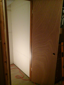 Drywall and door installation in progress during a home renovation project by Work Horse Contracting in West Fargo, ND.
