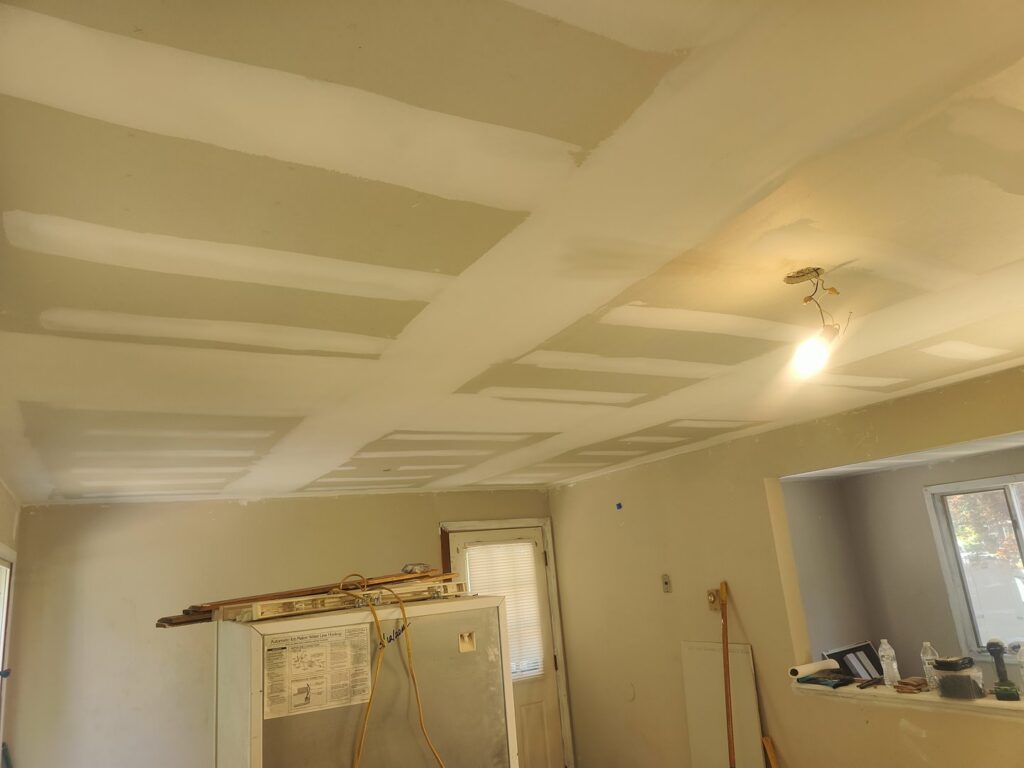 Drywall ceiling with taping and mudding in progress, showing quality finish work by New England Drywall in Springfield, MA.