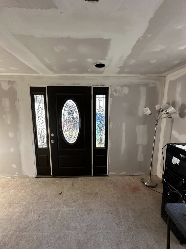 An entryway with a decorative door and walls prepared with drywall finishing by A Bit Of Everything LLC in Cranston, RI.