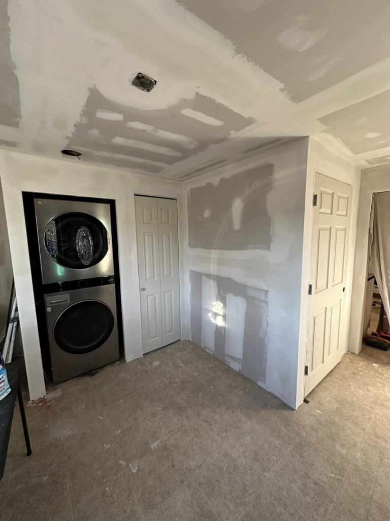An interior laundry area with new drywall finishing work in progress by A Bit Of Everything LLC in Cranston, RI.