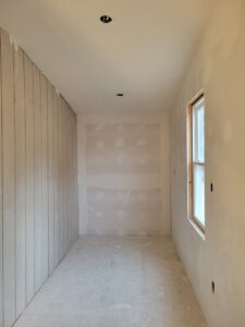 Drywall finishing and wood paneling installation in a room by M&M Drywall and Construction in Enid, OK