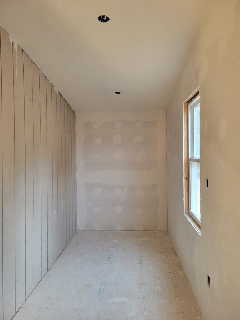 Drywall finishing and wood paneling installation in a room by M&M Drywall and Construction in Enid, OK