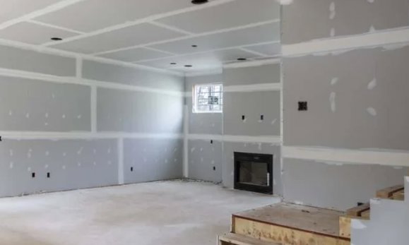 A room with new drywall installed and taped, ready for finishing, completed by McCollister Contracting LLC in New Castle, DE.