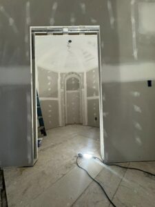Drywall installation in progress, including a unique domed ceiling, by Tribute Painting & Drywall in St. Louis, MO.