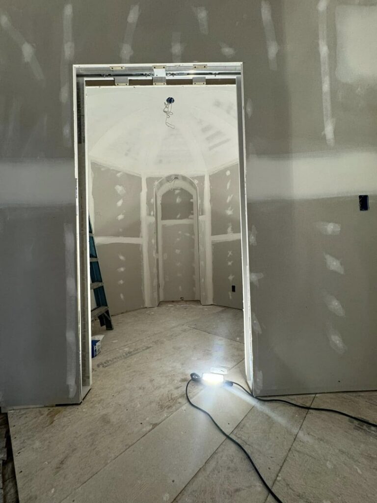 Drywall installation in progress, including a unique domed ceiling, by Tribute Painting & Drywall in St. Louis, MO.