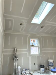 A room with newly installed drywall, taped and mudded, ready for finishing by Castle Drywall & Plaster in Chesapeake, VA.
