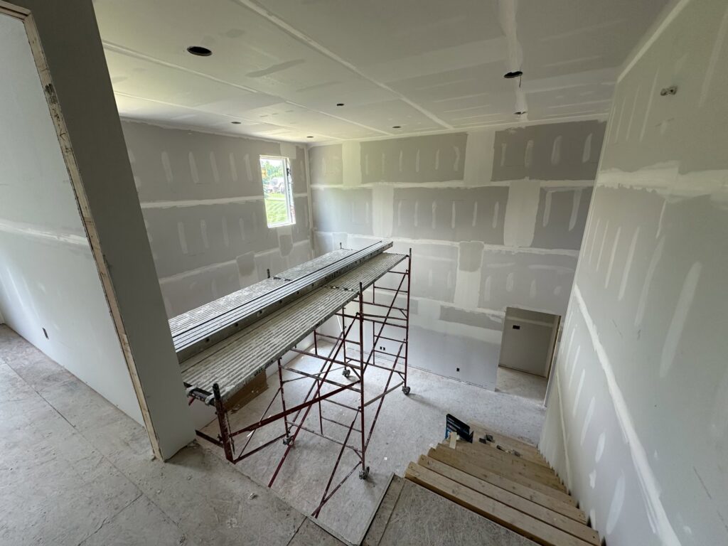 Extensive drywall installation and finishing in progress with scaffolding by Hahn Brothers Drywall Co Inc in Evansville, IN