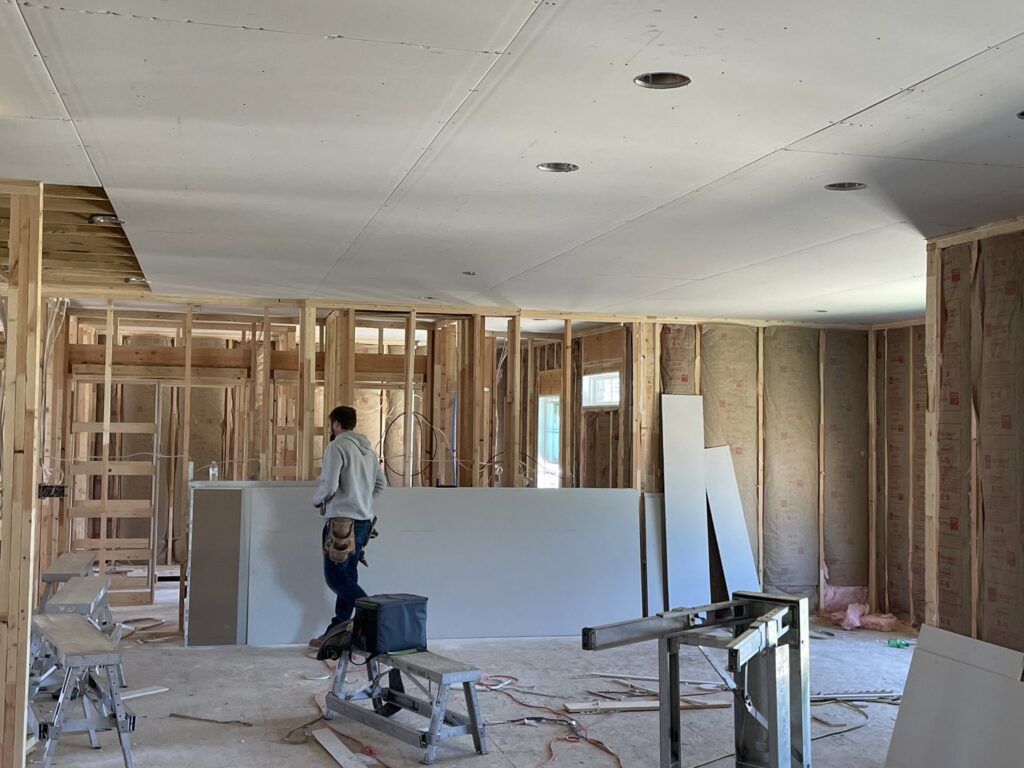 A worker preparing for drywall installation in a framed and insulated room by Hahn Brothers Drywall Co Inc in Evansville, IN