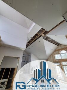 Drywall installation in a room with a high, vaulted ceiling by FG Drywall, Finishing and Painting in Champaign, IL.