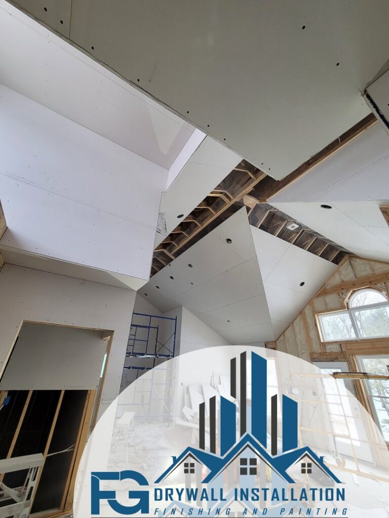 Drywall installation in a room with a high, vaulted ceiling by FG Drywall, Finishing and Painting in Champaign, IL.
