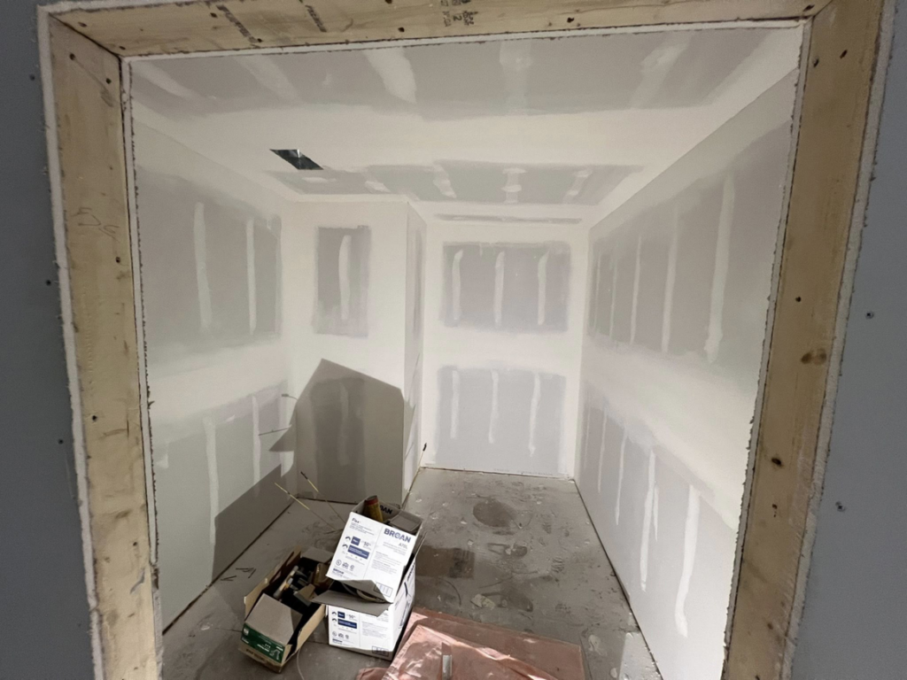 Drywall installation and finishing in progress for a room, showcasing handyman services by Brown & Son Contracting in O'Fallon, MO.